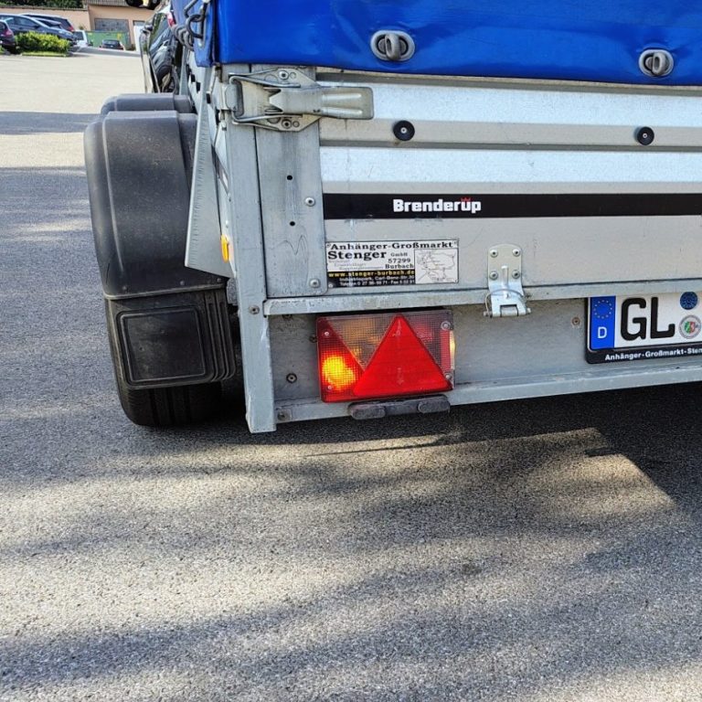 Rückansicht eines Fahrzeugs mit Warntriangle und Rücklicht.